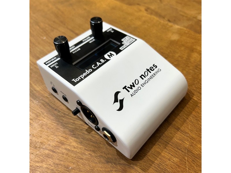 end your pedalboard or amp tone straight to the PA or recording setup with consistent, studio-quality sound. • Adjust every parameter directly from the Torpedo C.A.B. M’s onboard screen, or take full advantage of the Torpedo Remote interface on your computer or mobile device. • Access a complete virtual studio that lets you mic your guitar rig like a professional engineer. • If the built-in 32 cabinets aren’t enough, explore the world’s largest cabinet library via the Two notes Store, or load third-party IRs through your memory card. • The high-contrast, fast-response OLED screen delivers sharp, clear graphics. • All of this comes housed in a compact, rugged metal chassis built to withstand the demands of live performance. The Torpedo C.A.B. M is the crucial link between your guitar rig and the PA system or audio interface. Powered by Torpedo Technology, the C.A.B. M provides all the advantages of premium, mic’d-cabinet sound—perfect for players who want to record or perform live without dealing with microphones or complex wiring. As a standalone unit, the Torpedo C.A.B. M includes 32 Two notes virtual cabinets, 8 microphones, and 8 rooms right out of the box. With the Remote software, you can control the unit from your desktop via USB or wirelessly from your phone or tablet. Connections: • Instr/Line Input: connect your guitar, pedalboard, or your amp’s speaker output. • Speaker Output: connect your cabinet here when running your amp into the Amp In. • Input Level: choose from three gain settings (-24, 0, +12 dB) to match your source. • USB: control the unit from a Windows or macOS computer using the Remote software. • Power: connect the included power adapter. • Headphone Output: for silent practice or monitoring. • Aux In: play along with backing tracks from an external device. • Ground Lift: eliminate ground loop hum when needed. • DI Out: balanced XLR output for connecting to a mixer or audio interface. • Line Out: balanced TRS output for mixers or audio interfaces.